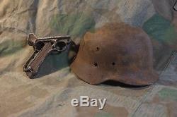 Original german ww2 battle damaged helmet and other battle remain for display
